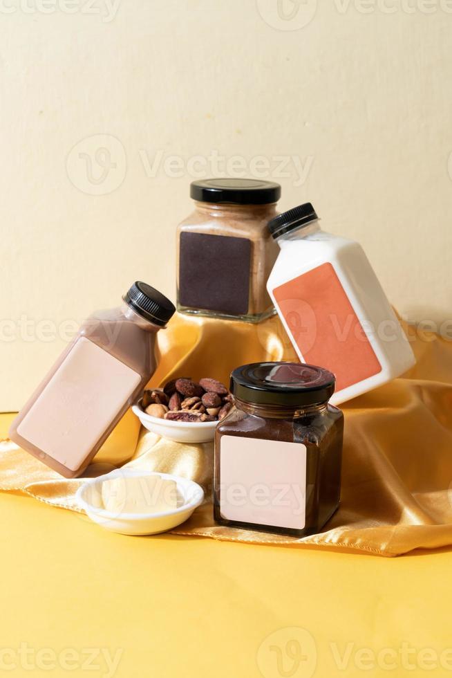 Almond butter spread and almond chocolate butter spread jar with almond milk and almond chocolate milk bottle on table photo