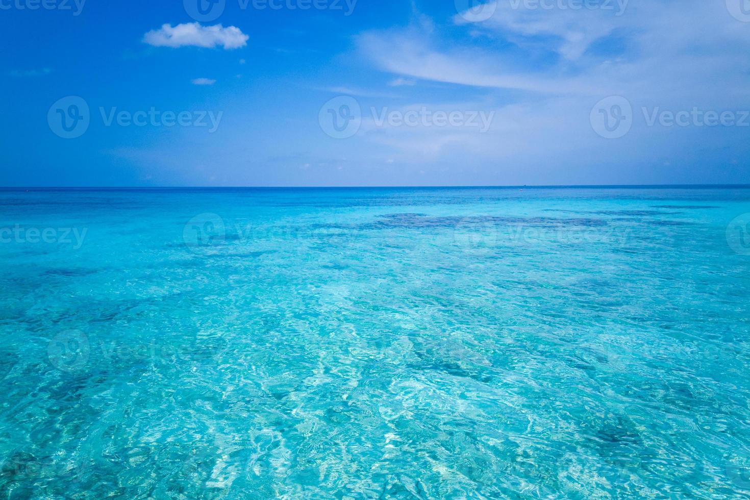 Clear sea waves and white sandy beach in summer. photo