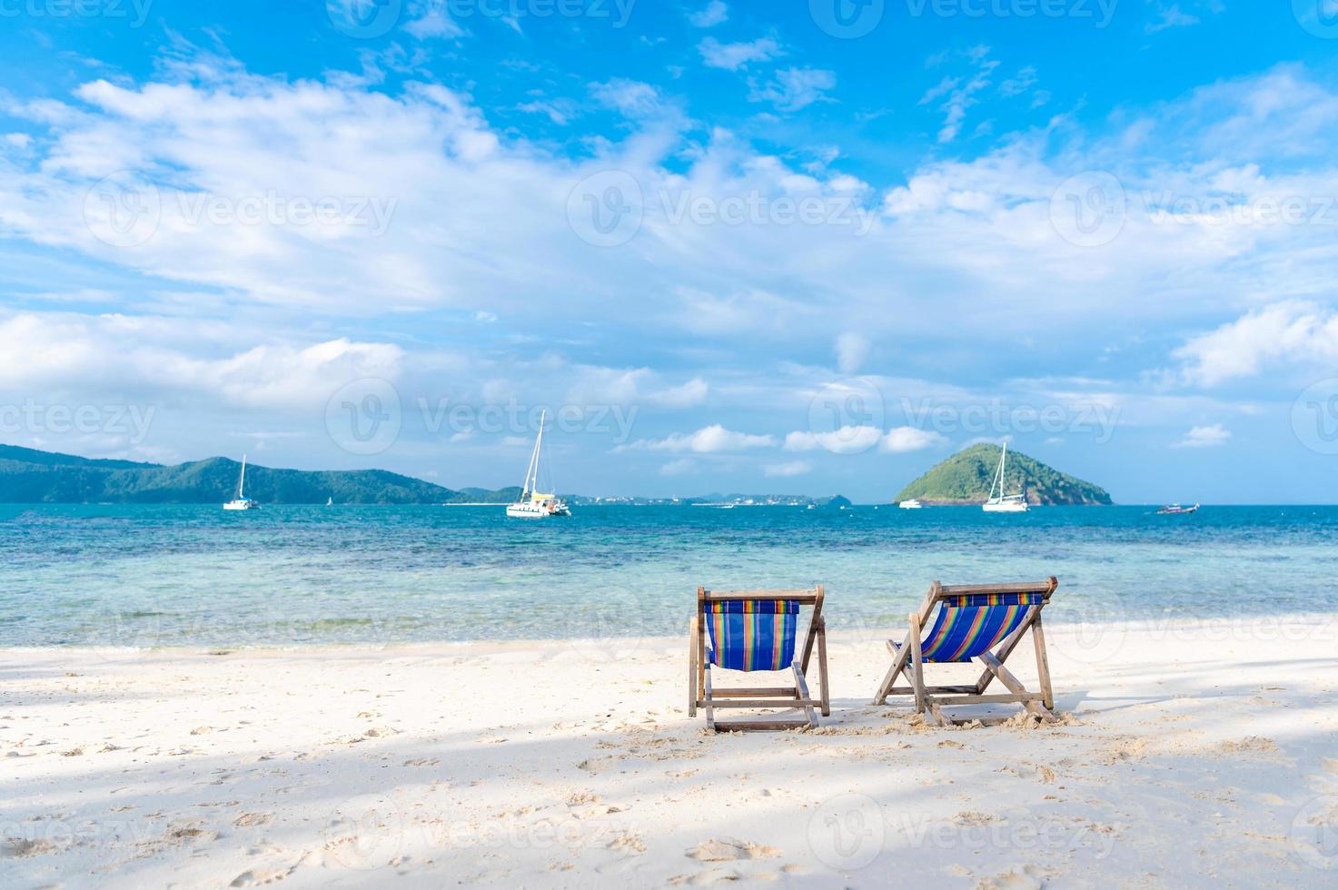Beach bed on white sand and clear sea in the summer photo