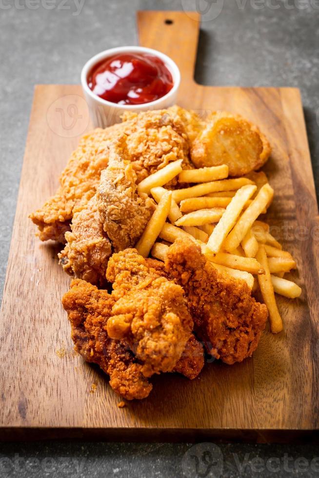 Pollo frito con papas fritas y nuggets de comida - comida chatarra y comida malsana foto