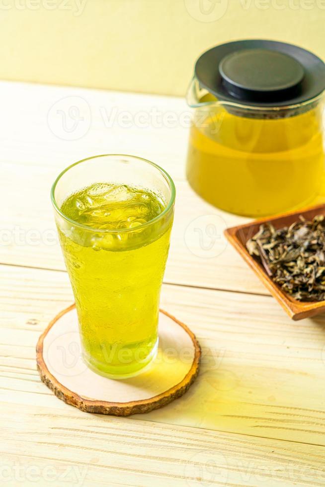 Iced Japanese green tea on wood background photo