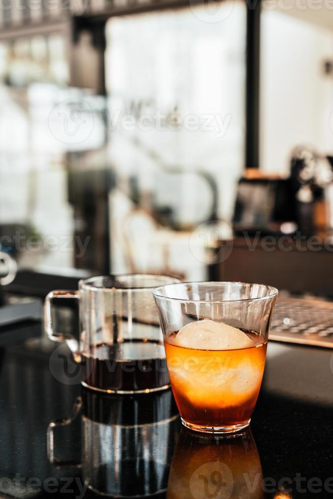 Cold drip Arabica black coffee in glass with ice ball photo
