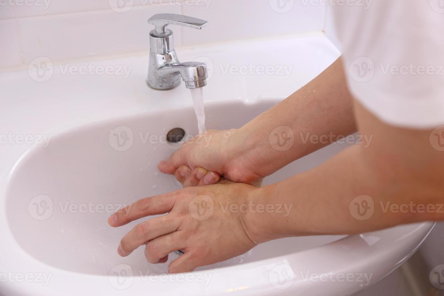 Hand Washing in Washbasin photo