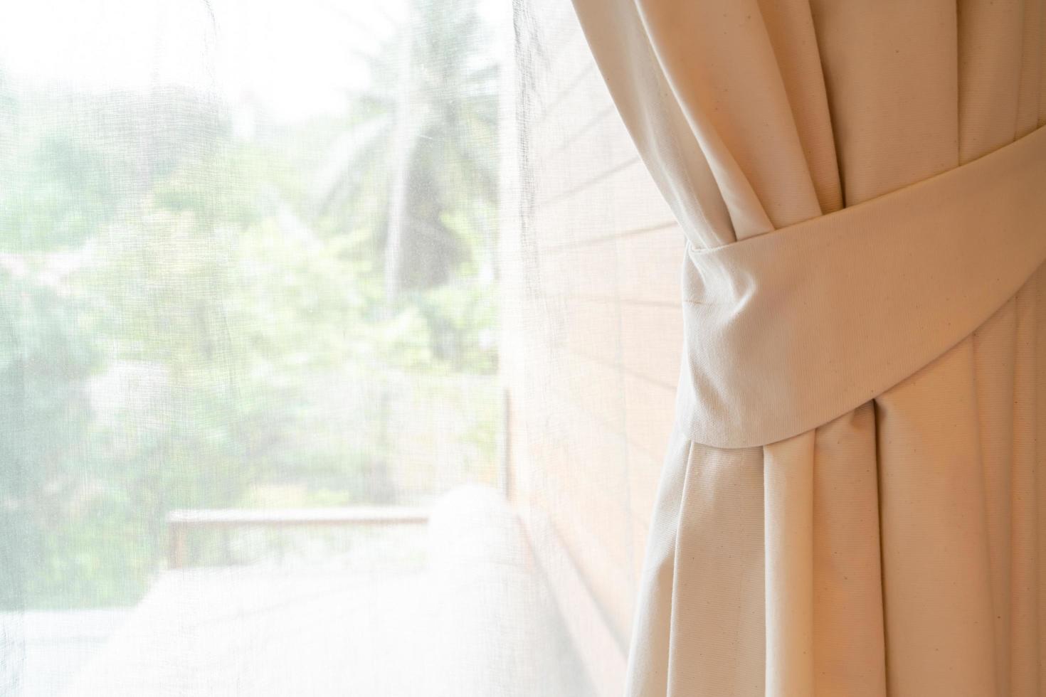 Close-up curtain with window and sunlight photo