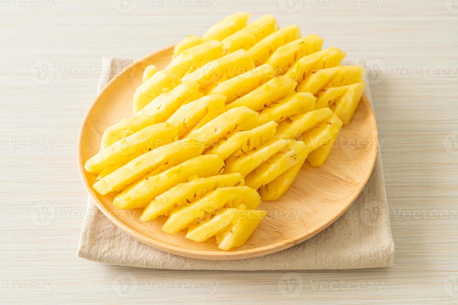 Fresh pineapple sliced on white plate photo