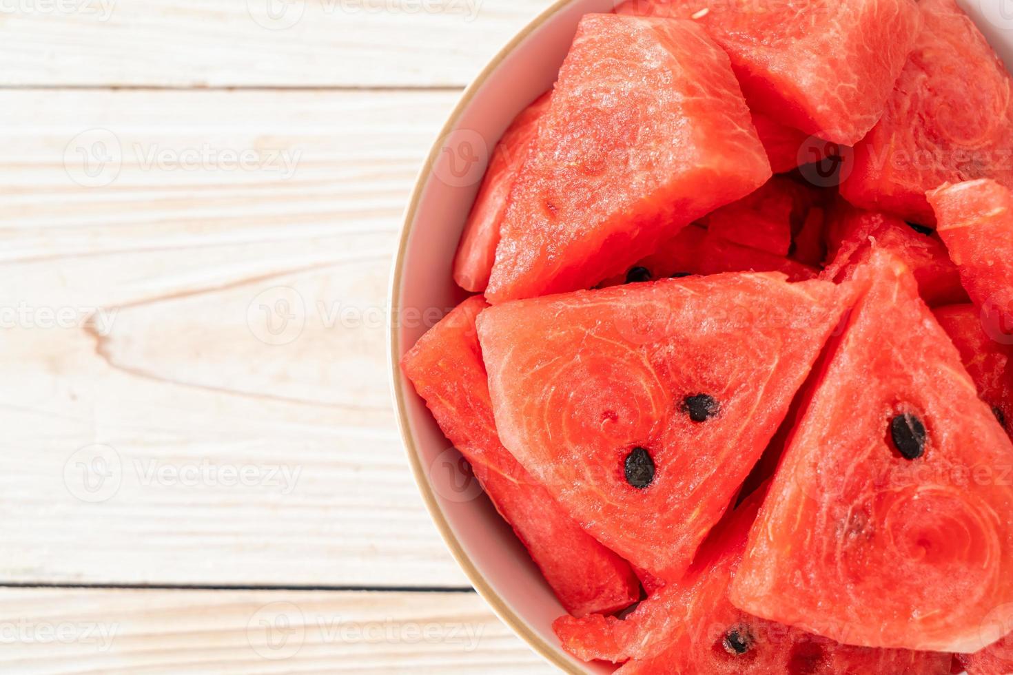 Fresh watermelon sliced in white bowl photo