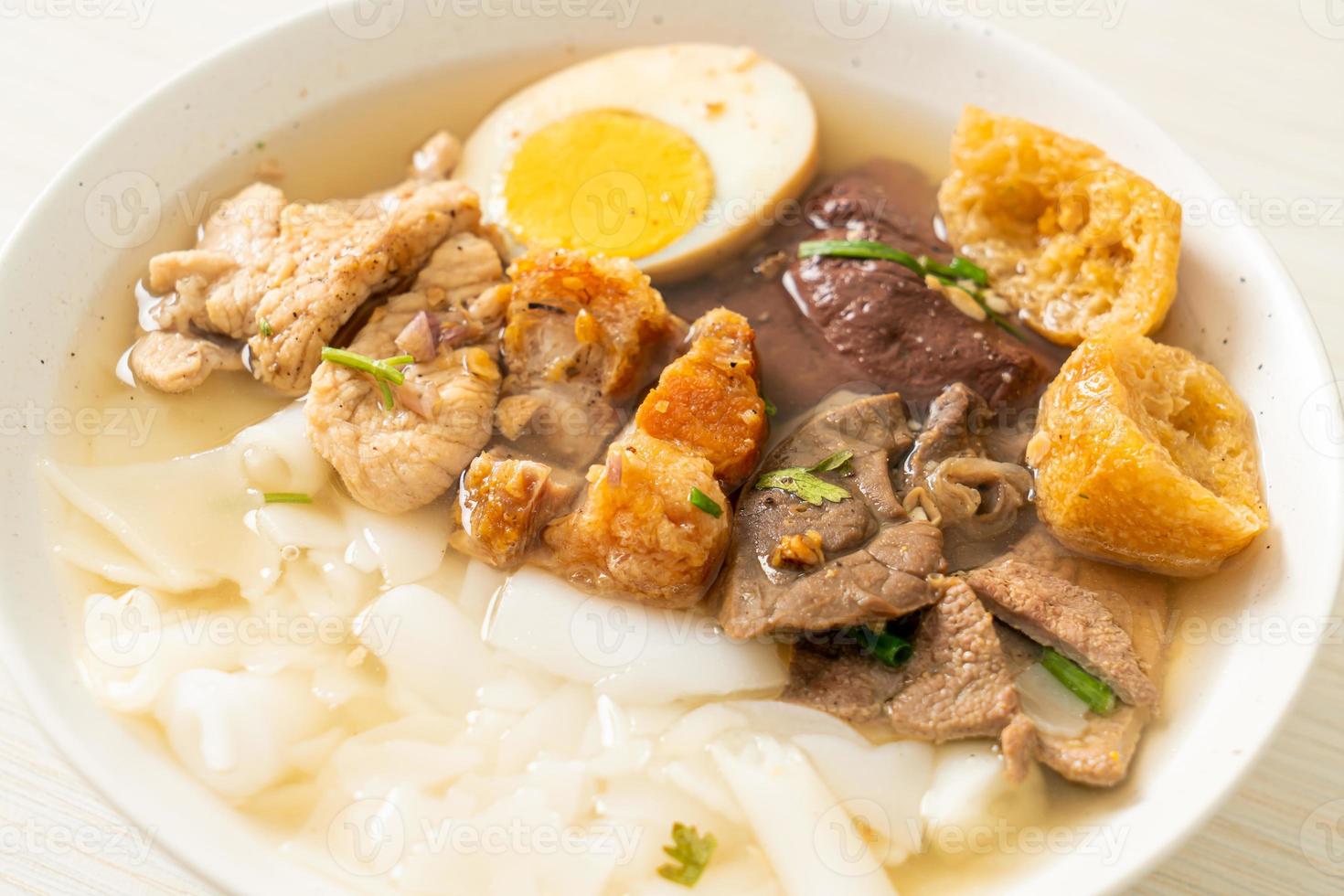 Paste of rice flour or boiled Chinese pasta square with pork in brown soup - Asian food style photo