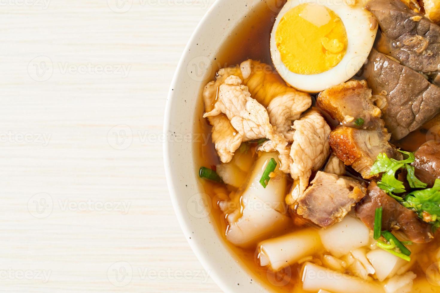 Paste of rice flour or boiled Chinese pasta square with pork in brown soup - Asian food style photo