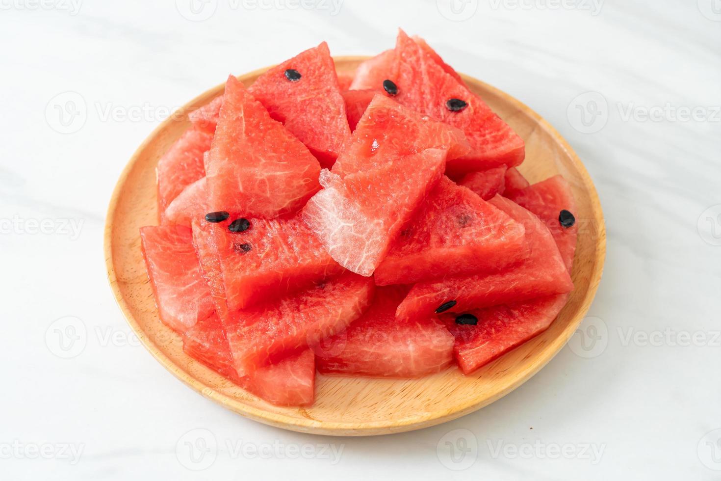 Fresh watermelon sliced on wooden plate photo