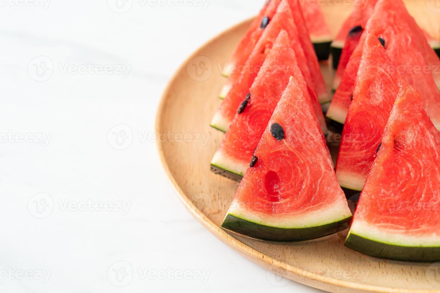 Fresh watermelon sliced on wooden plate photo