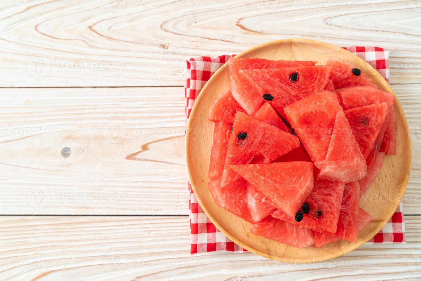 Fresh watermelon sliced on wooden plate photo