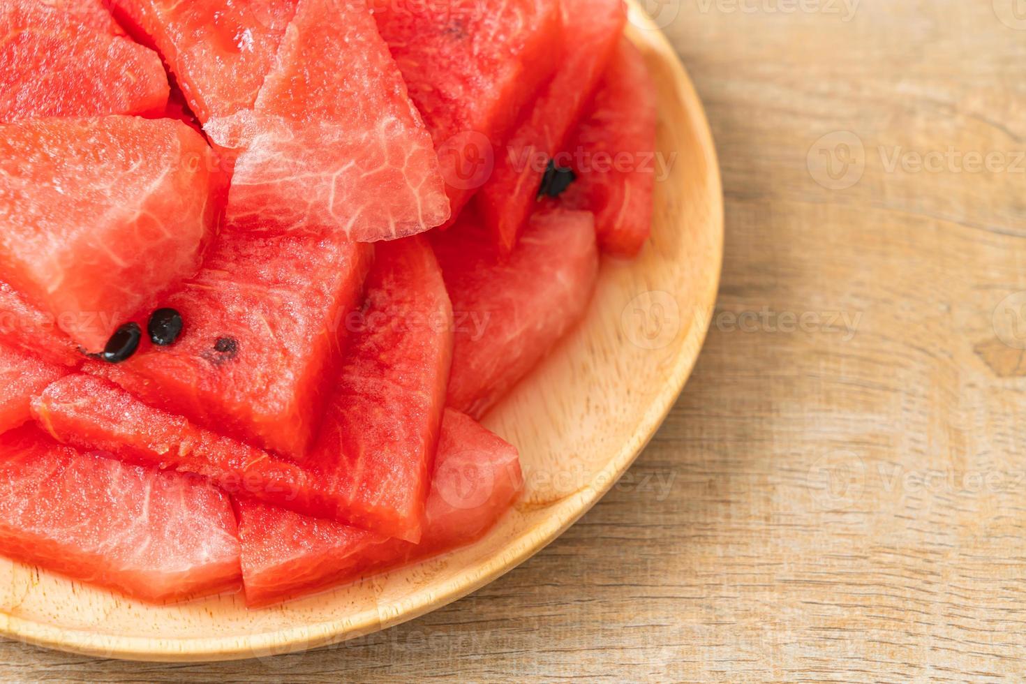 Fresh watermelon sliced on wooden plate photo