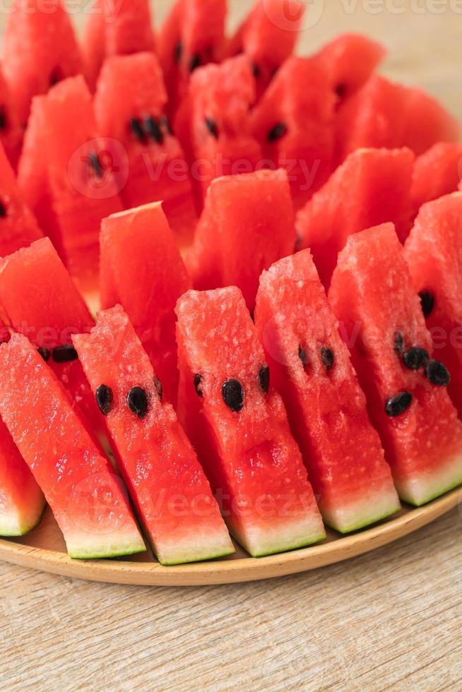 Fresh watermelon sliced on wooden plate photo