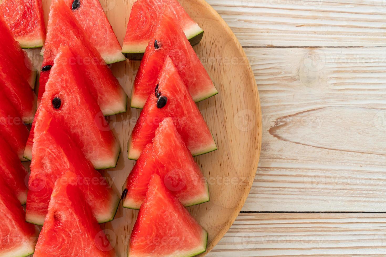 Fresh watermelon sliced on wooden plate photo