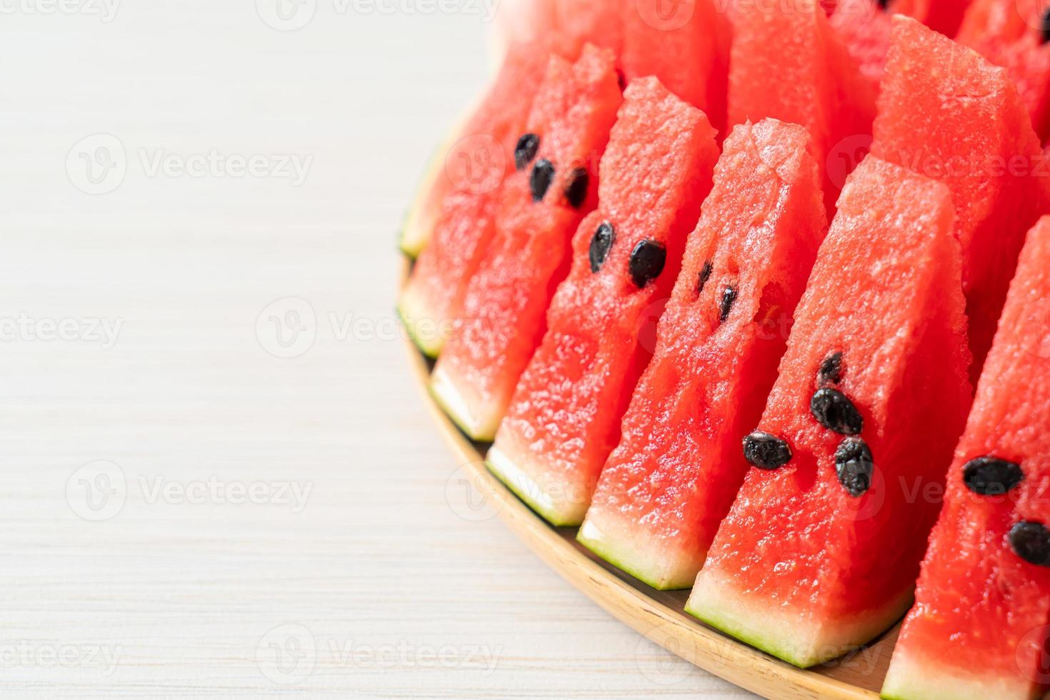 Fresh watermelon sliced on wooden plate photo