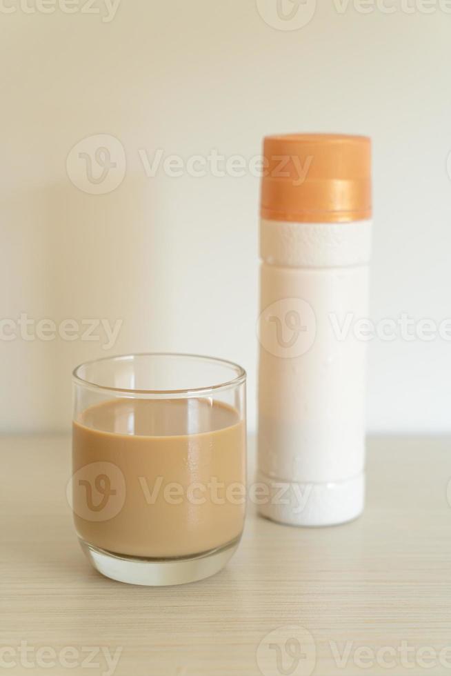 Coffee latte glass with ready to drink coffee bottles on the table photo