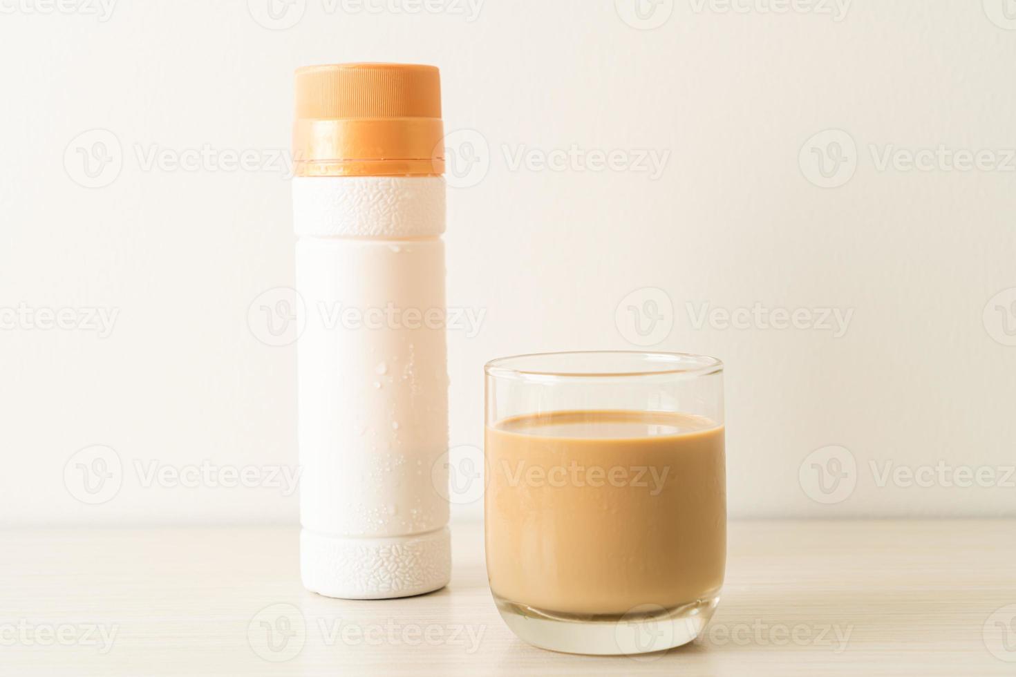 Coffee latte glass with ready to drink coffee bottles on the table photo