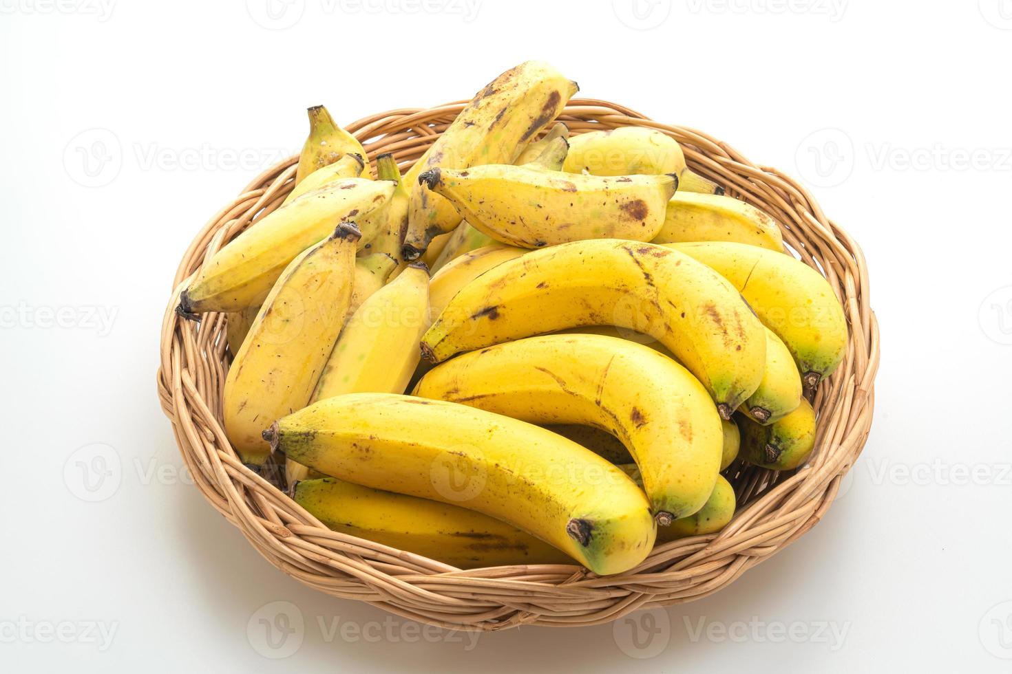 Fresh yellow bananas in basket on the table photo