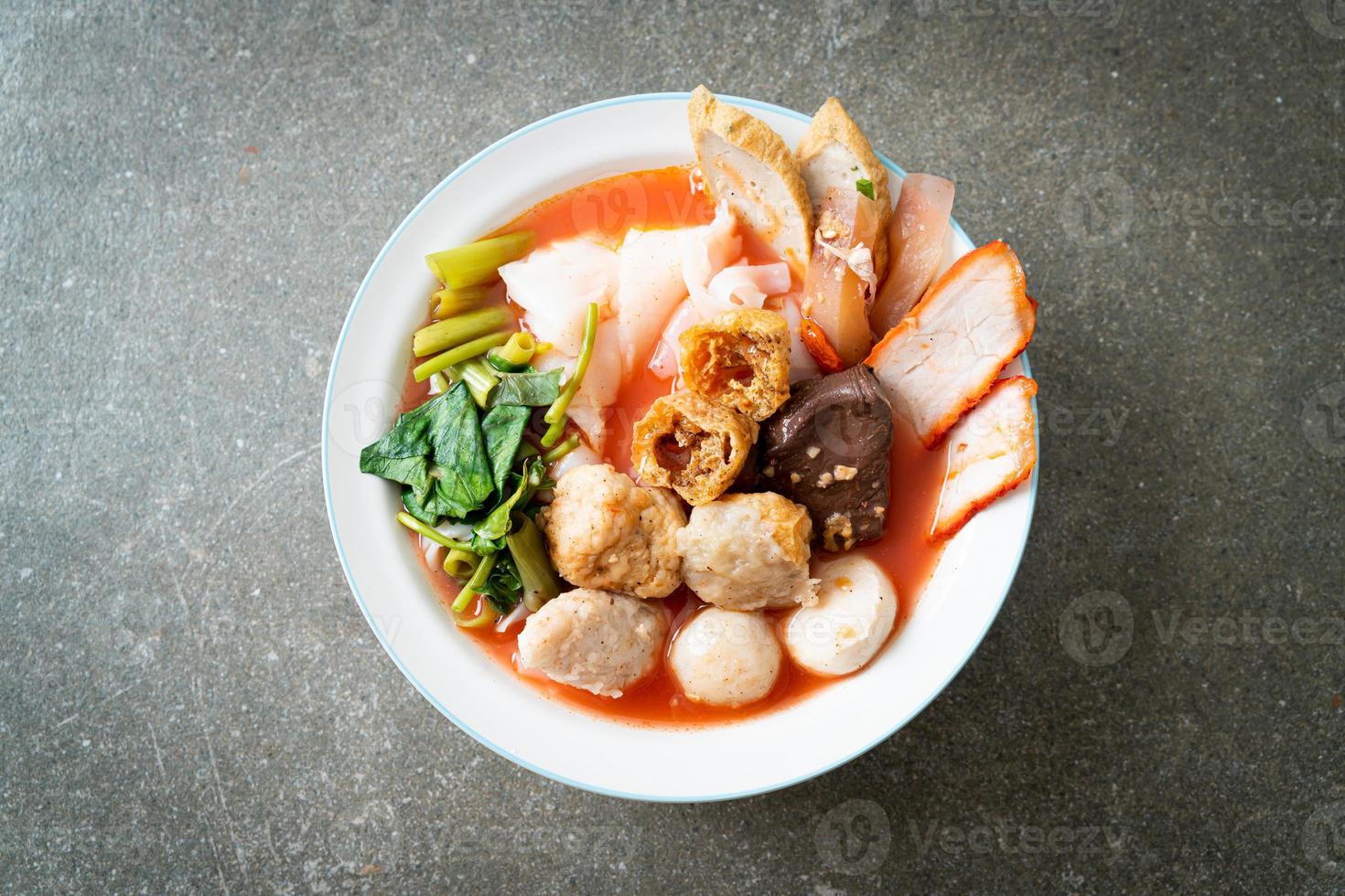 Noodles with meatballs in pink soup or Yen Ta Four Noodles in Asian style photo