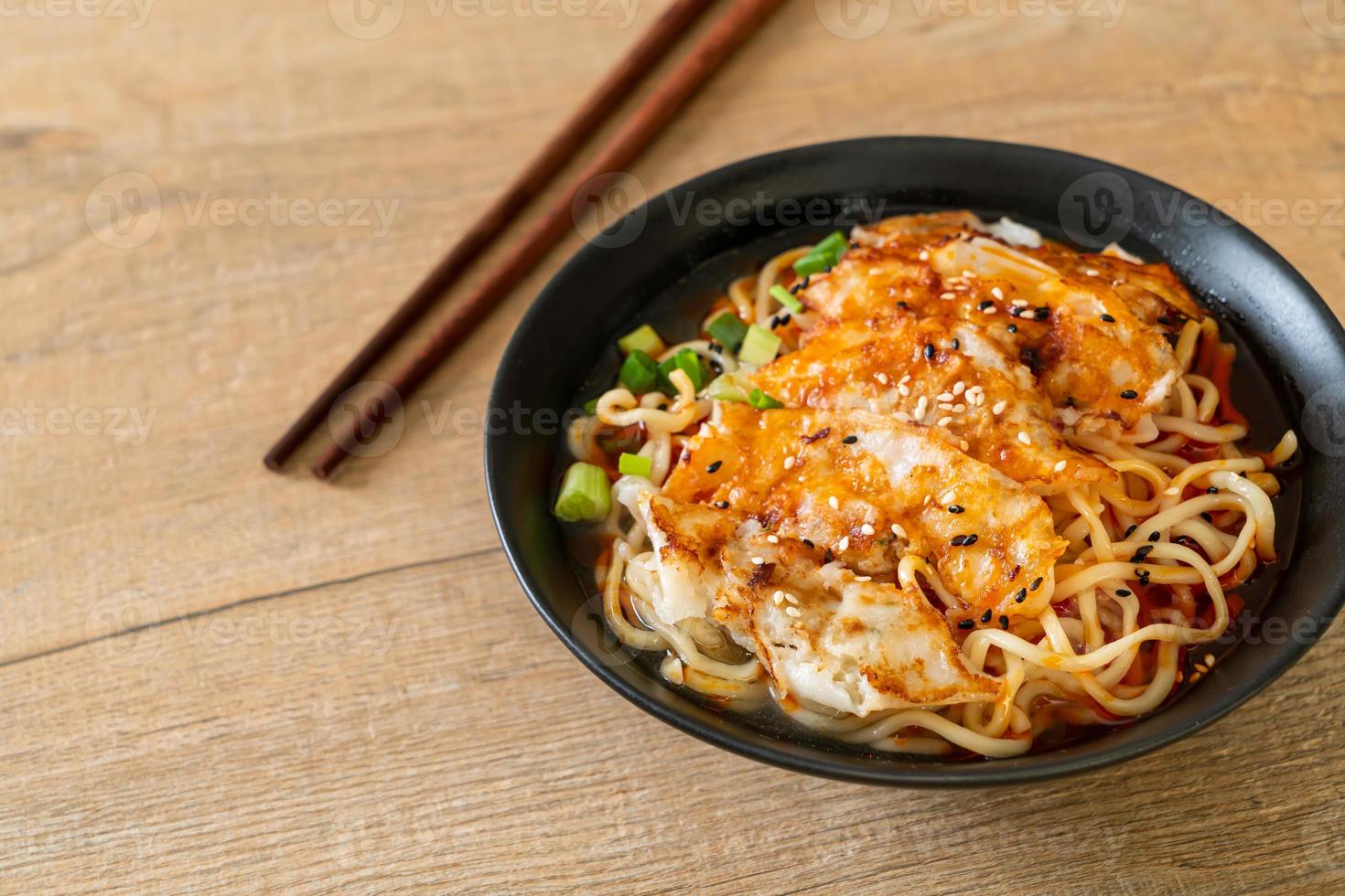 Ramen noodles with gyoza or pork dumplings - Asian food style photo