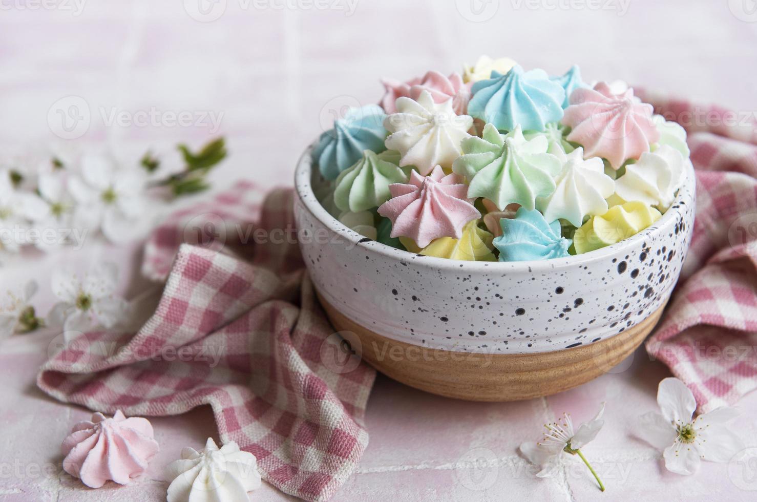 Small colorful meringues in the  ceramic bowl photo