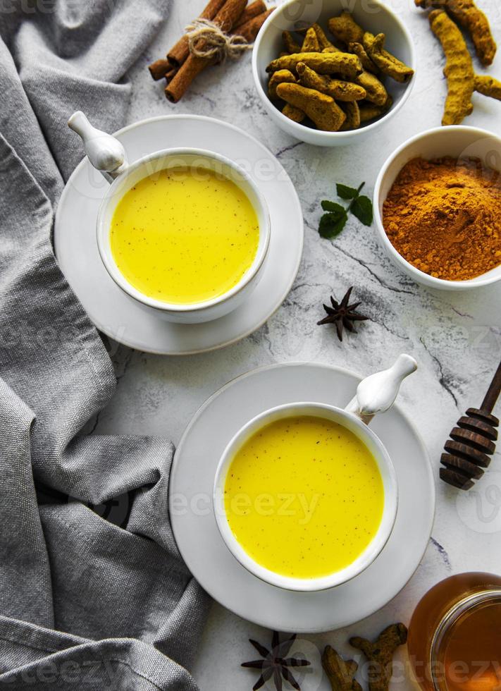 Yellow turmeric latte drink. photo