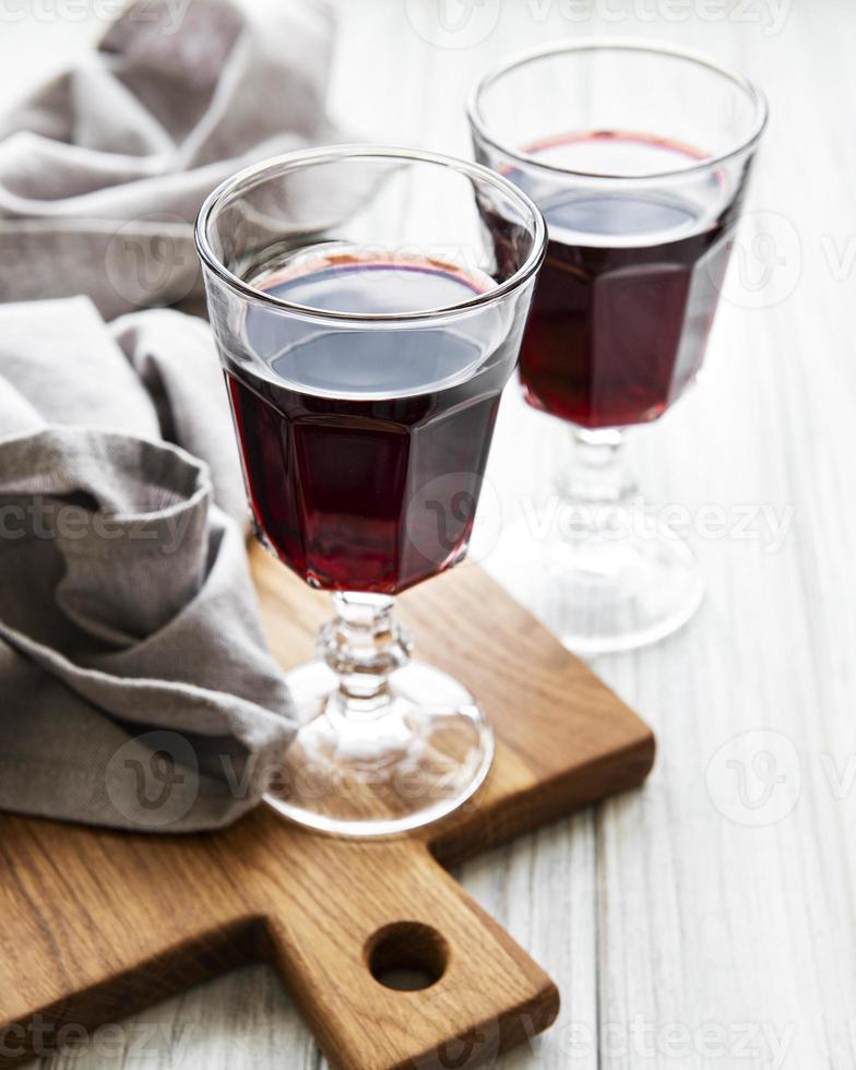 Cherry liqueur in a glass and fresh fruits photo