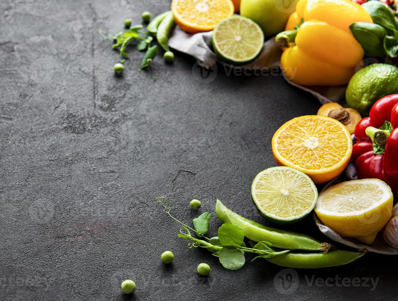 Healthy food. Vegetables and fruits on a black concrete background. photo