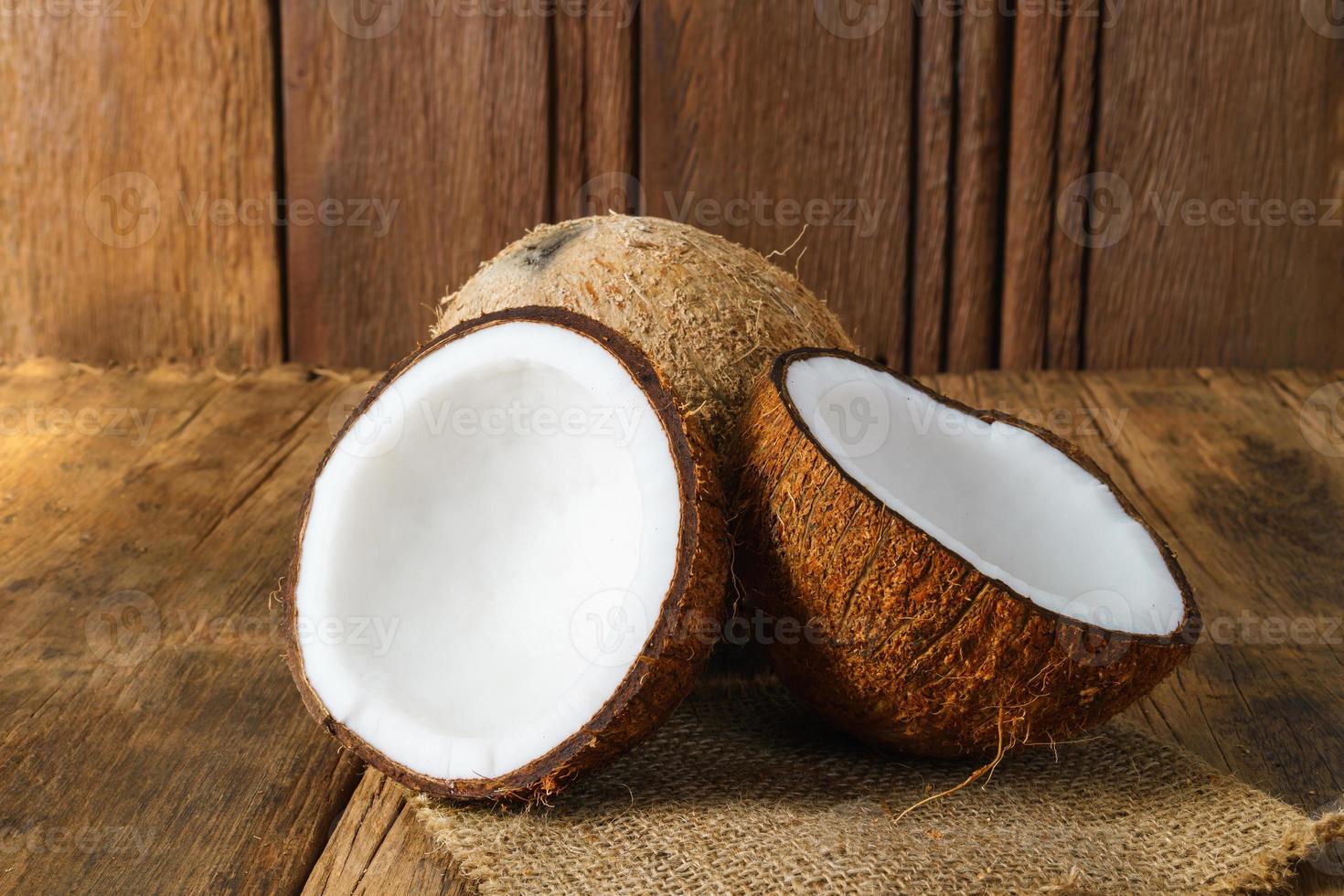 Fresh coconuts on old wooden background photo