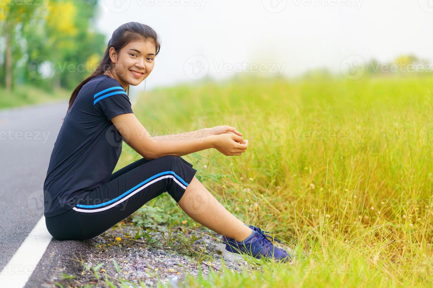 Portrait of beautiful girl in sportswear smiling during exercise photo