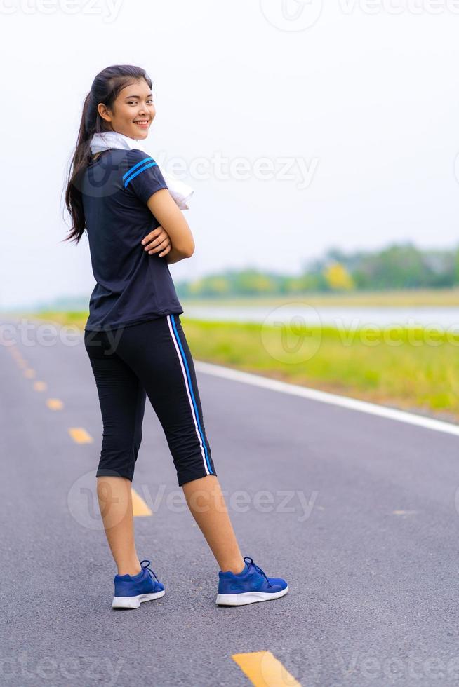 Portrait of beautiful girl in sportswear smiling during exercise photo