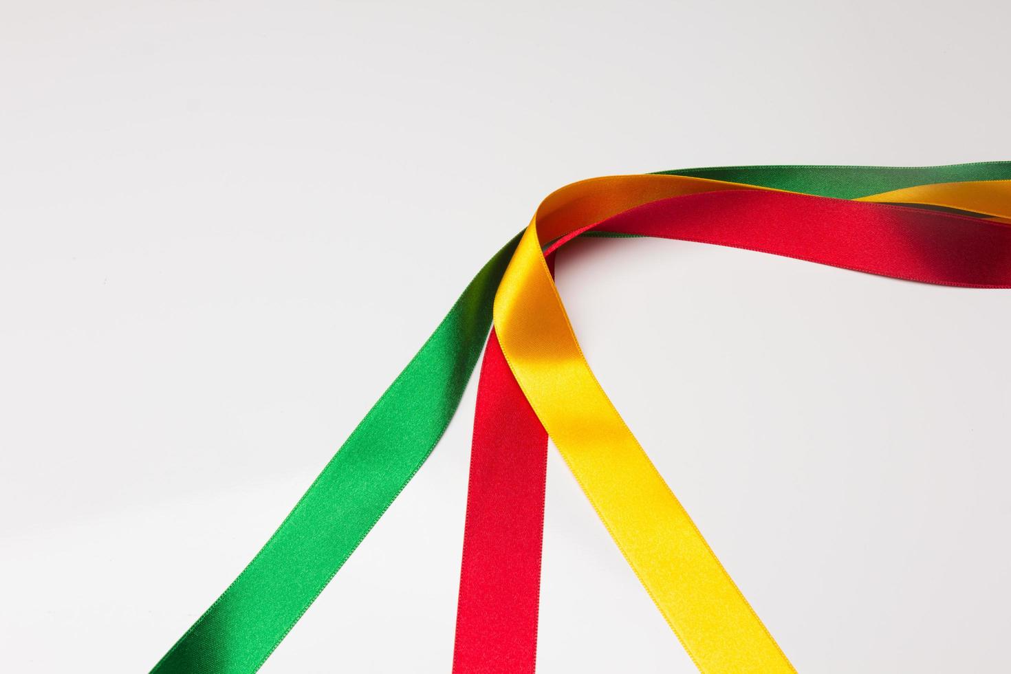 Coloured fabrics and ribbons, basic colours on a white background photo