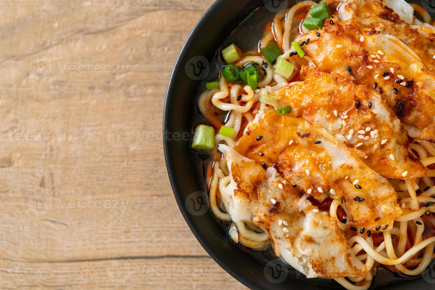 Ramen noodles with gyoza or pork dumplings - Asian food style photo