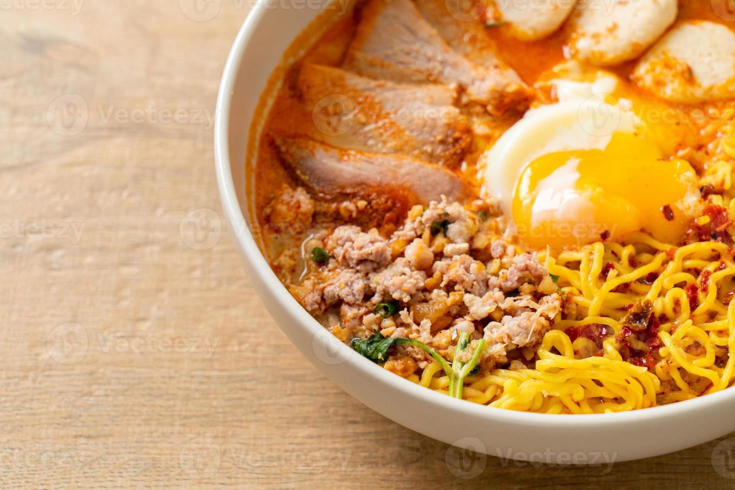 Egg noodles with pork and meatball in spicy soup or Tom Yum Noodles in Asian style photo