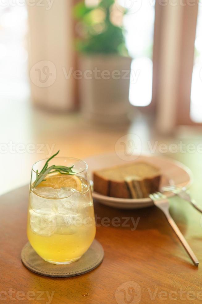 Iced lemon honey glass with rosemary in cafe restaurant photo