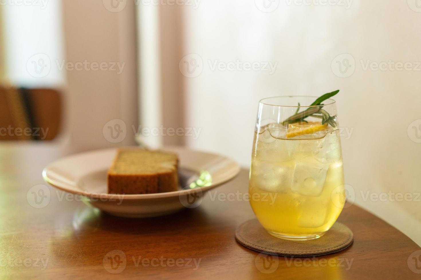 Iced lemon honey glass with rosemary in cafe restaurant photo