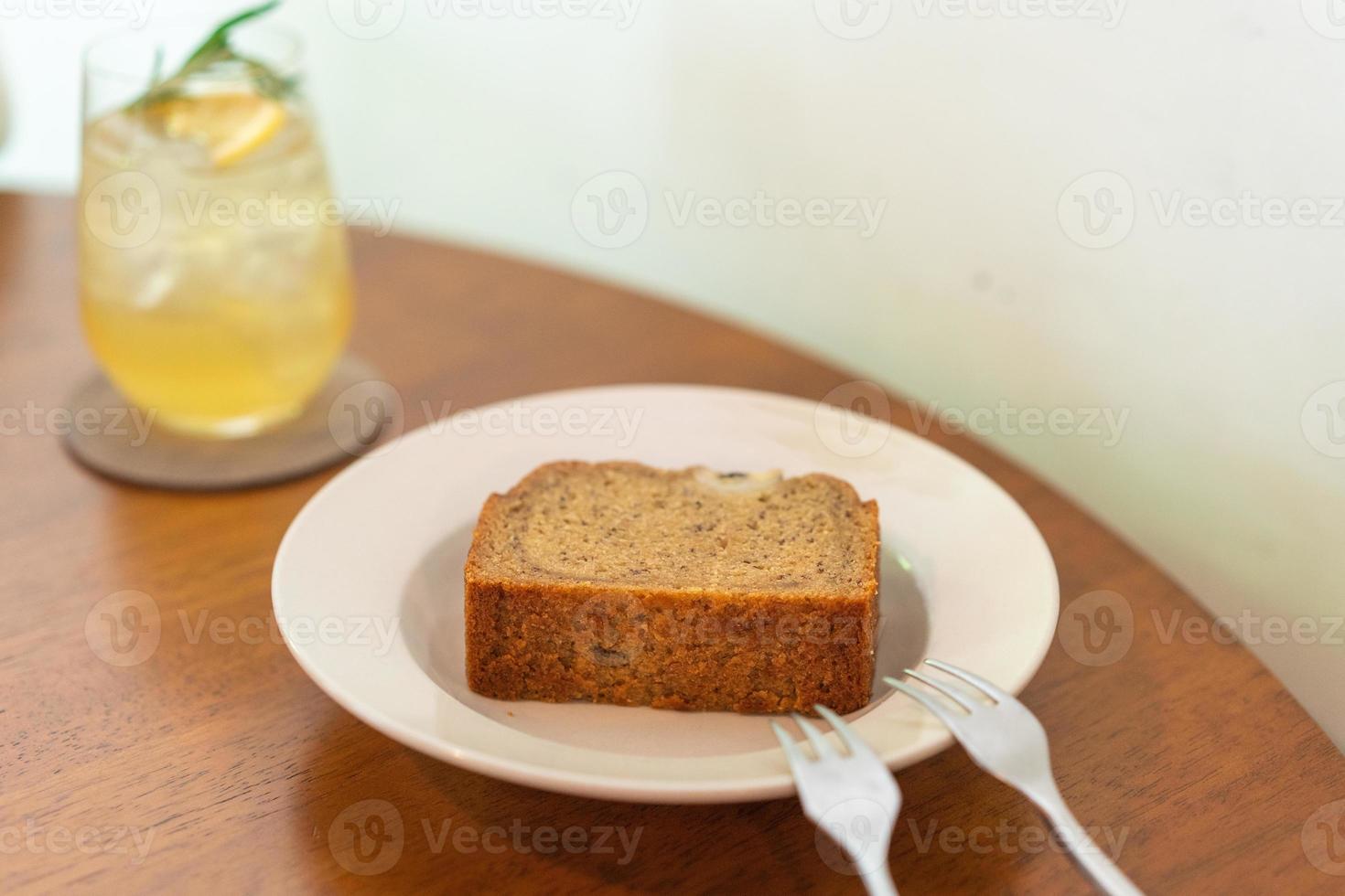 Banana cake on plate in cafe restaurant - soft selective focus point photo