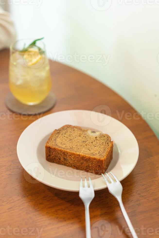 Banana cake on plate in cafe restaurant - soft selective focus point photo