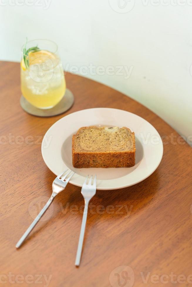 Banana cake on plate in cafe restaurant - soft selective focus point photo