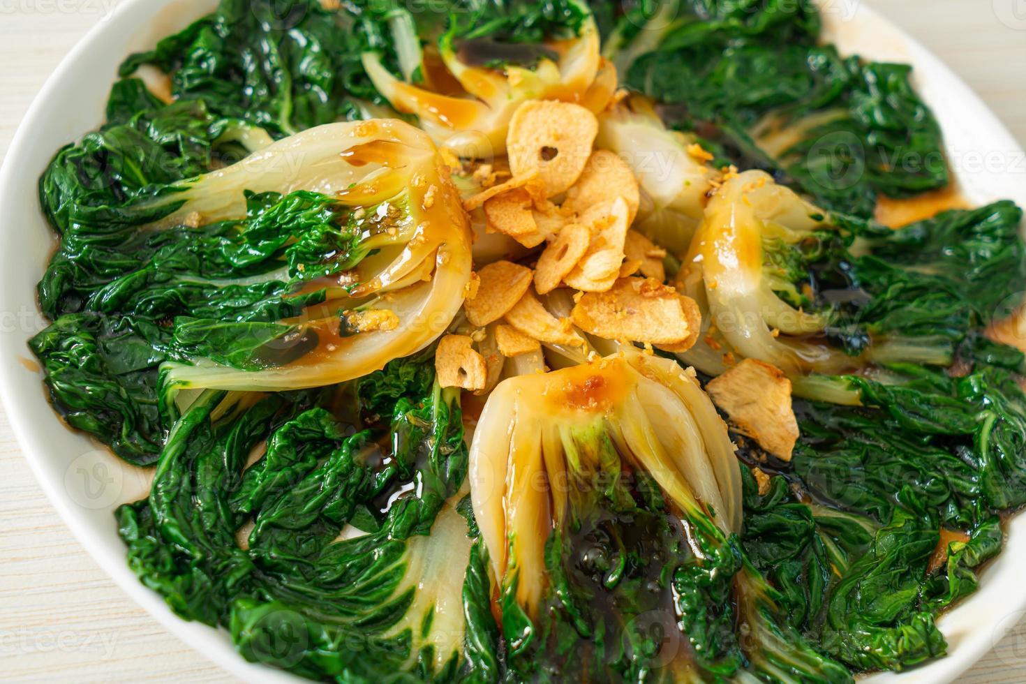 Baby Chinese cabbage with oyster sauce and garlic - Asian food style photo