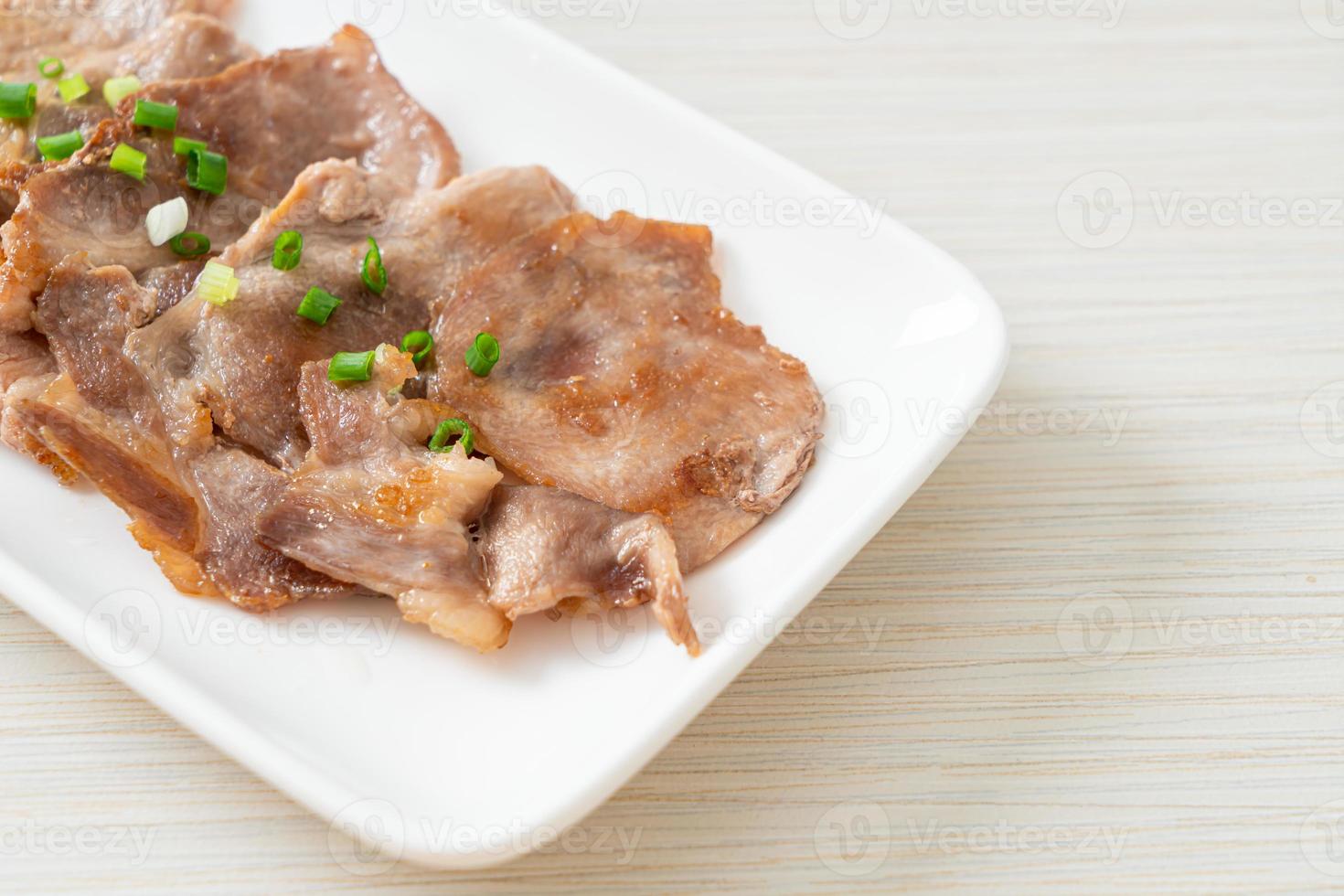 Grilled pork neck sliced on plate in Asian style photo