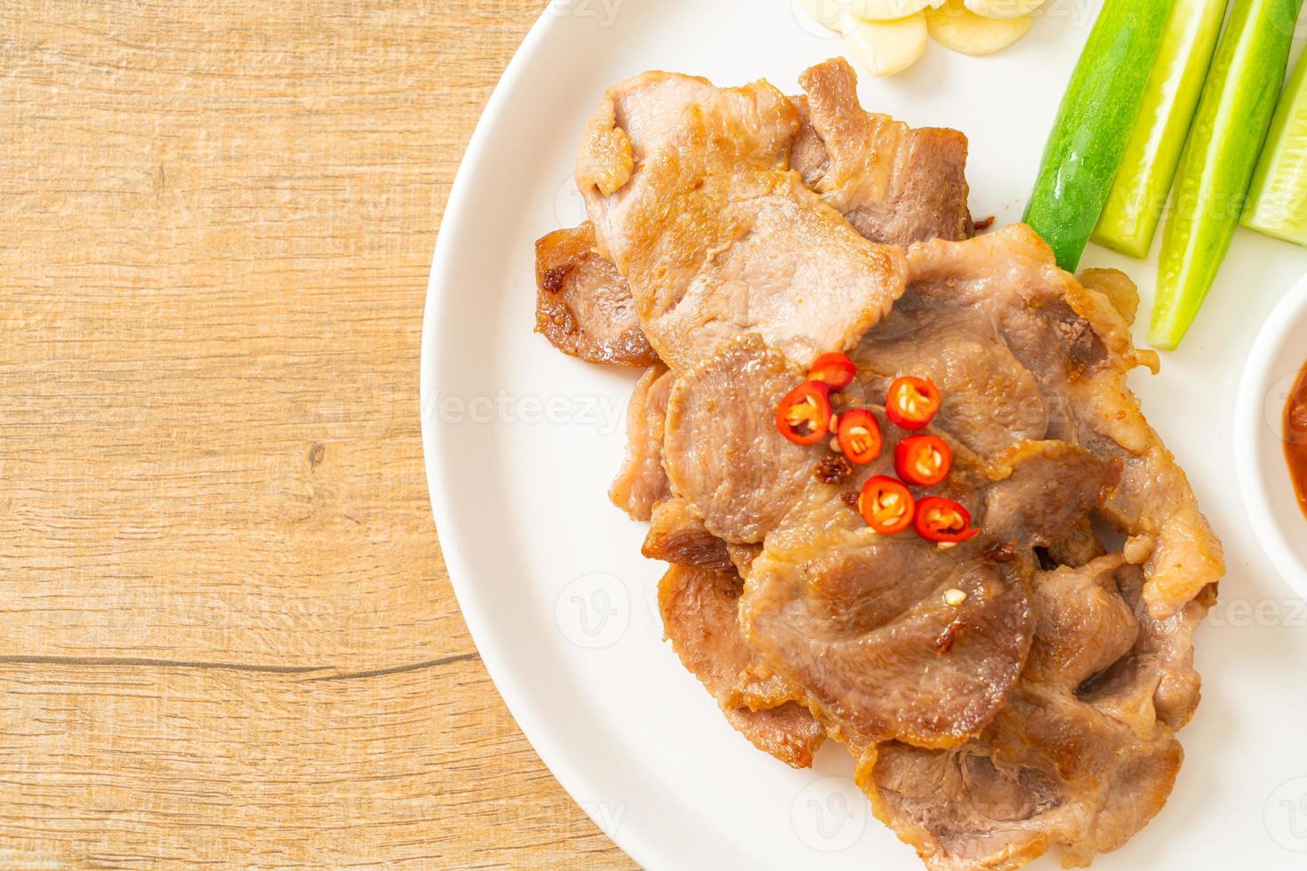 Grilled pork neck sliced on plate in Asian style photo