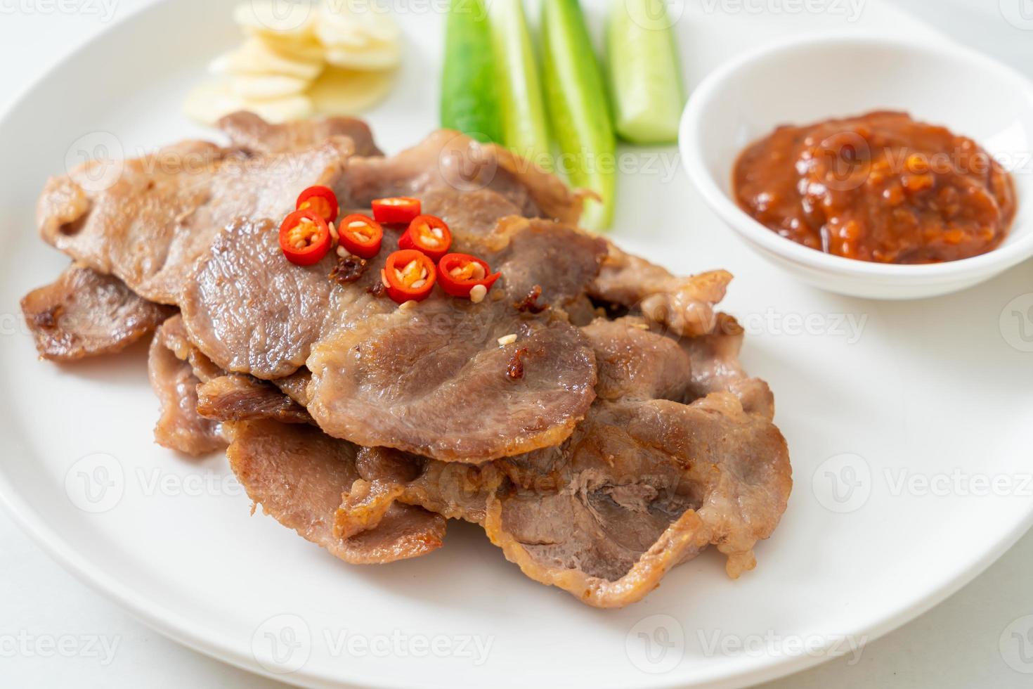 Grilled pork neck sliced on plate in Asian style photo