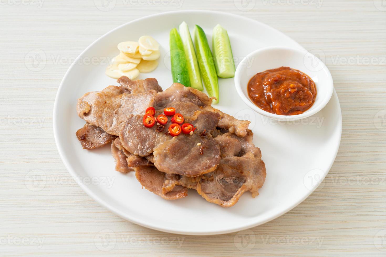 Grilled pork neck sliced on plate in Asian style photo