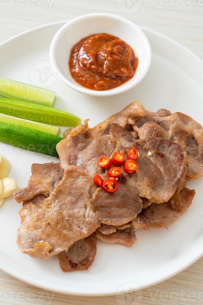 Grilled pork neck sliced on plate in Asian style photo