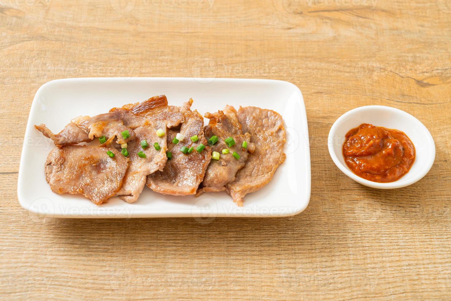 Grilled pork neck sliced on plate in Asian style photo