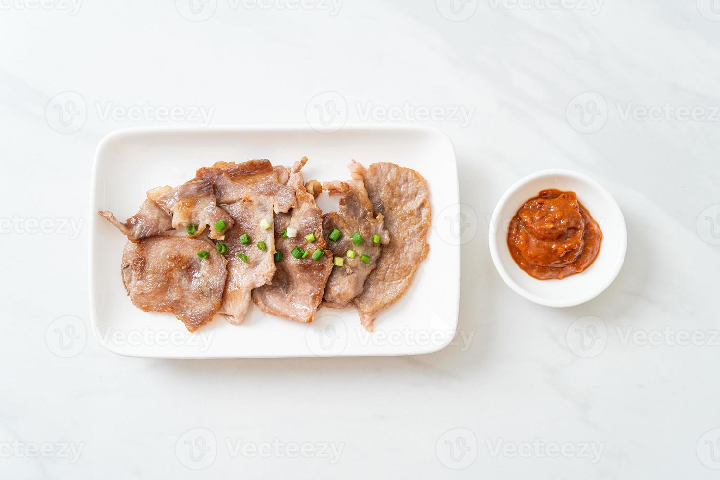 Grilled pork neck sliced on plate in Asian style photo