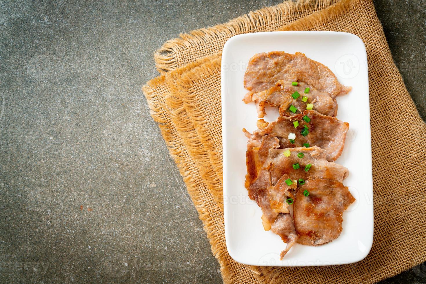 Grilled pork neck sliced on plate in Asian style photo