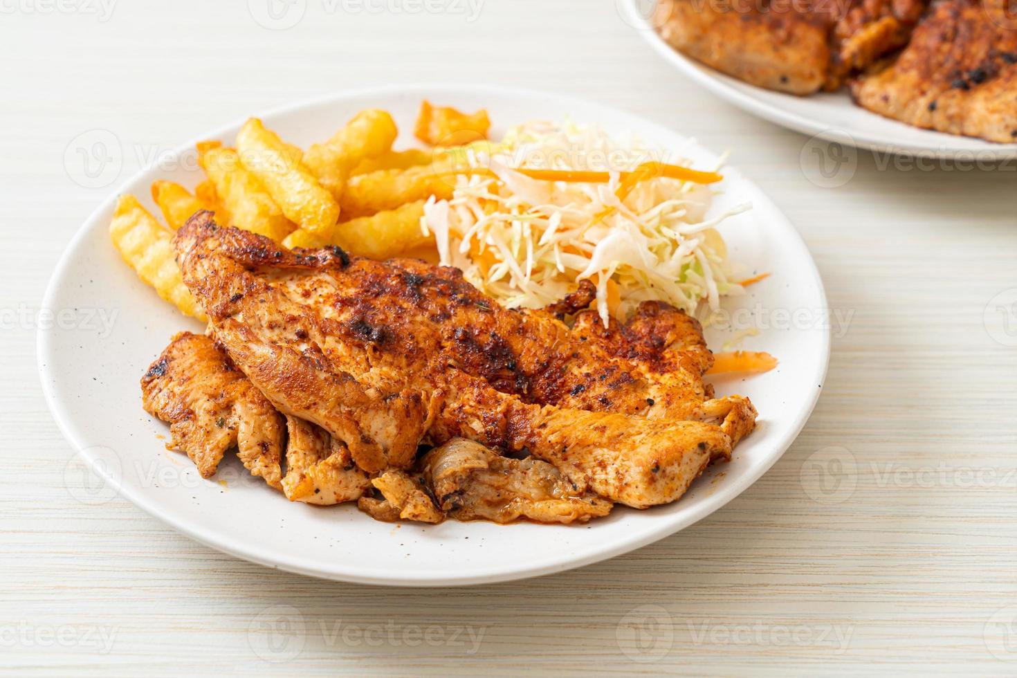 Grilled spicy barbecue chicken steak with french fries photo