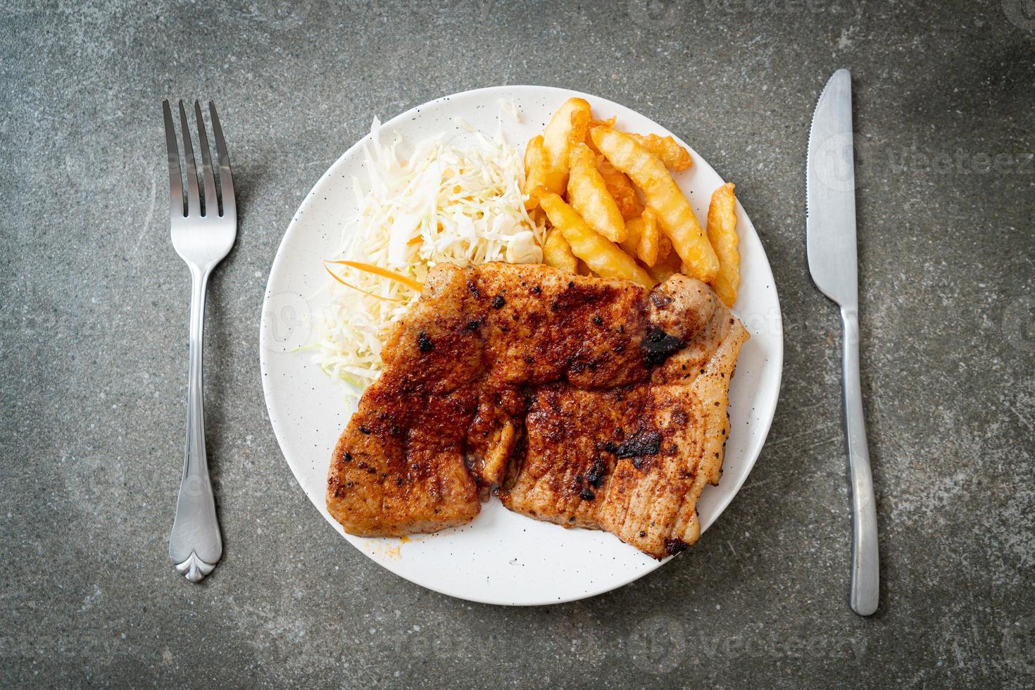 Grilled spicy barbecue kurobuta pork steak with french fries photo